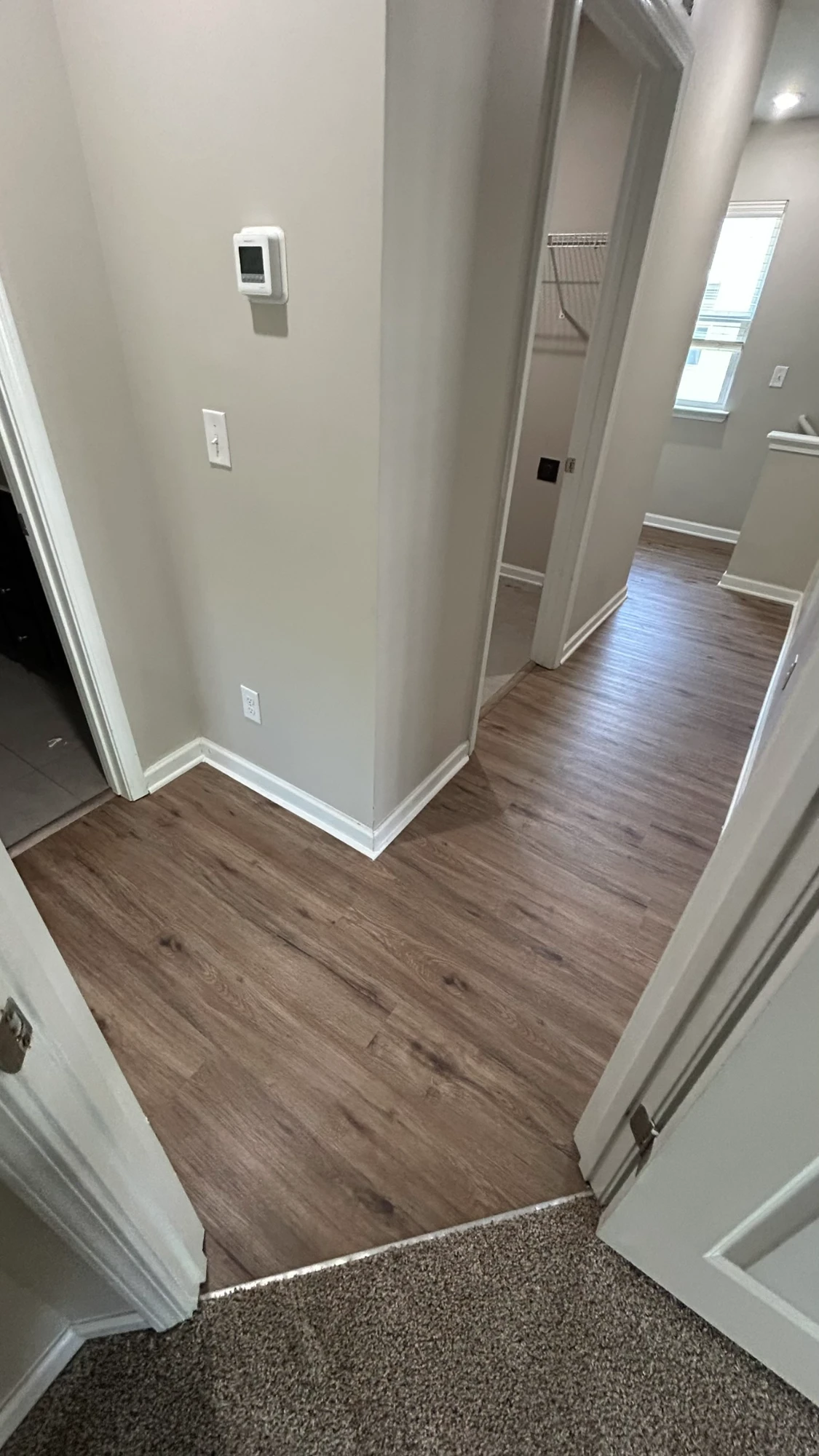 Charlotte, NC · Warm Oak LVP · Clean undercuts at doorways